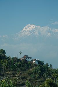 Scenic view of a rural village in Kaskikot, Nepal with majestic Annapurna mountain in the backdrop.