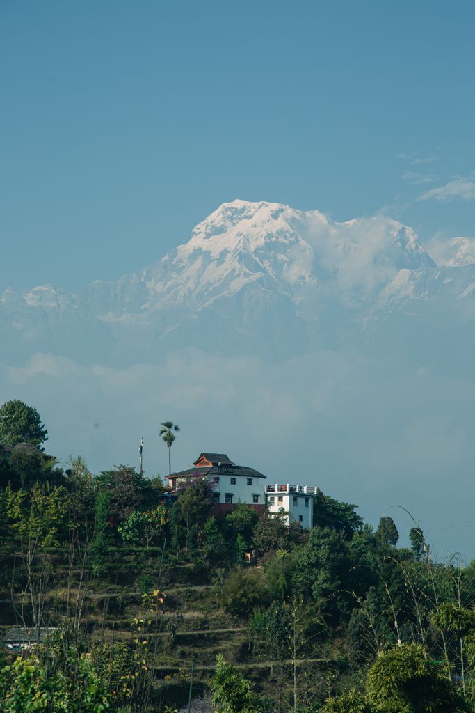 Scenic view of a rural village in Kaskikot, Nepal with majestic Annapurna mountain in the backdrop.